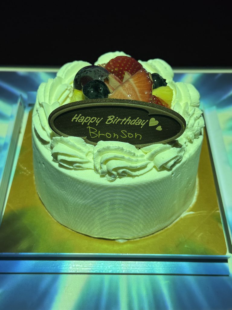 Fruit decorated birthday cake appearing through magic for Bronson at MagicBar ELEVEN Osaka
