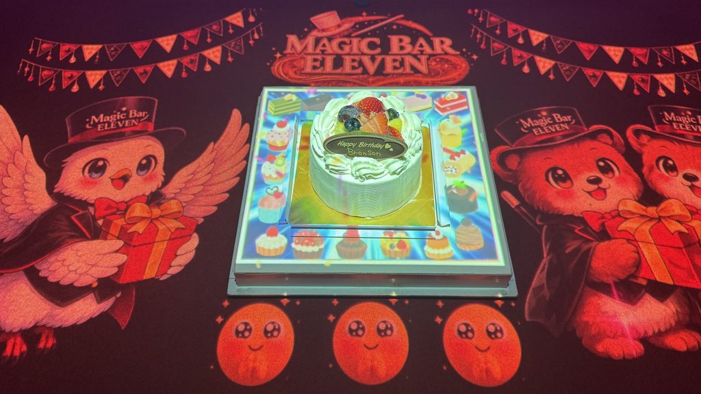 Projection mapping surrounding Bronson's birthday cake during a family celebration in Osaka